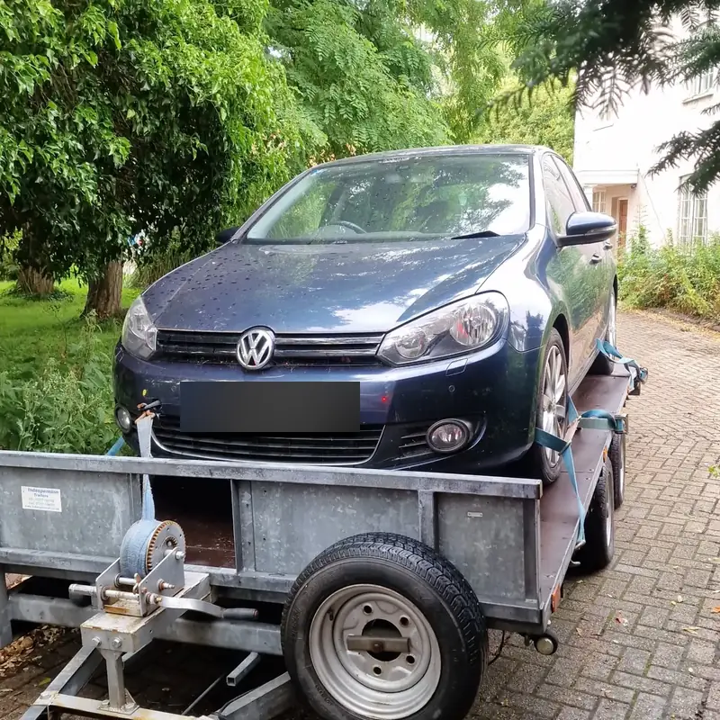Volkswagen Golf secured on a car transporter trailer
